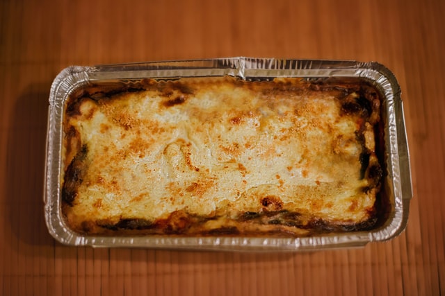 an image of lasagna baked in metallic food tray